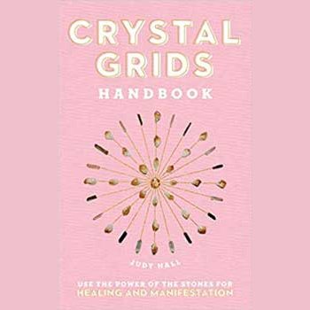 Crystal Grids Handbook hardcover by Judy Hall featuring geometric crystal design on pink cover.
