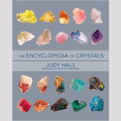 Encyclopedia of Crystals by Judy Hall book cover featuring various colorful crystals.