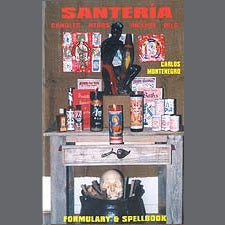 Santeria Formulary and Spellbook by Carlos Montenegro on a wooden table with spiritual candles and a skull decoration