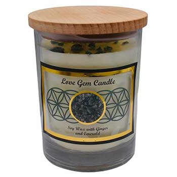 Love gemstone soy candle with emerald chips and ginger scent in glass jar with wooden cover.
