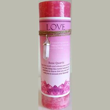 Love pillar candle with rose quartz pendant for intent and blessings.