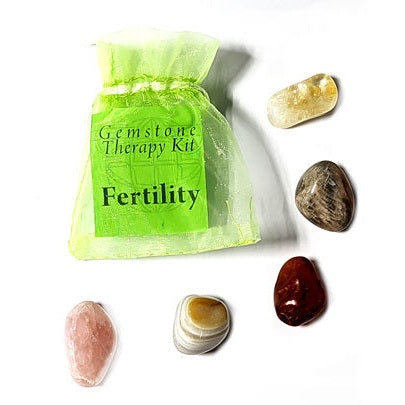 Fertility gemstone therapy kit with agate, carnelian, citrine, moonstone, and rose quartz in a green organza bag