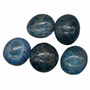 A pile of smooth, polished Apatite Tumbled Pebbles from Madagascar for meditation and energy healing, promoting empathy and balance