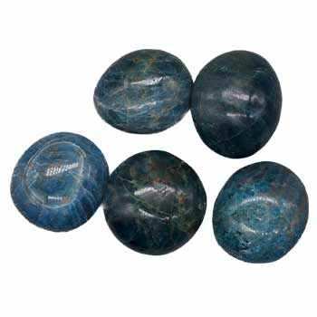 A pile of smooth, polished Apatite Tumbled Pebbles from Madagascar for meditation and energy healing, promoting empathy and balance