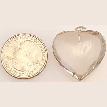 natural citrine heart pendant next to a US quarter for size comparison