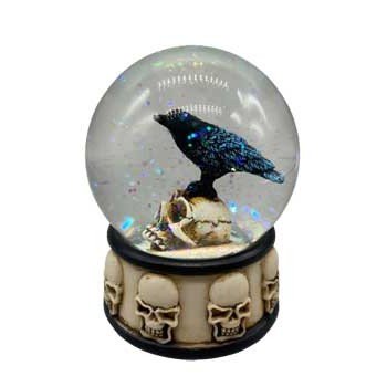 Raven on skull water globe with glitter and skull base design.