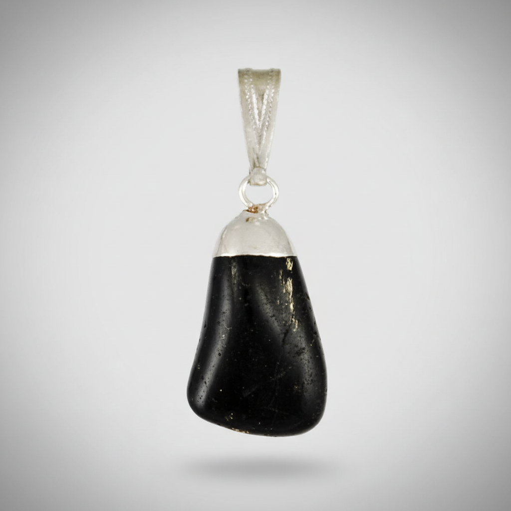 A highly detailed, photorealistic close-up of a glossy black tourmaline tumbled pendant, suspended against a soft, neutral background. The pendant is illuminated by a diffused daylight studio light, creating subtle highlights on its smooth, rounded surface