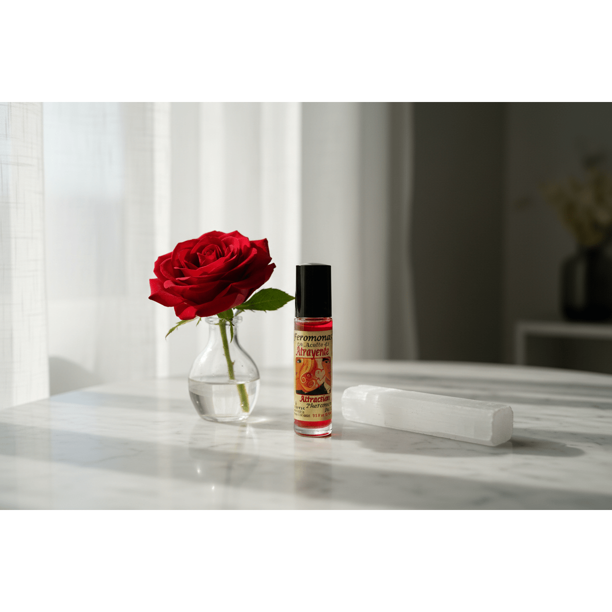 Attraction Perfume Oil roll-on bottle on marble surface near window with rose and selenite wand