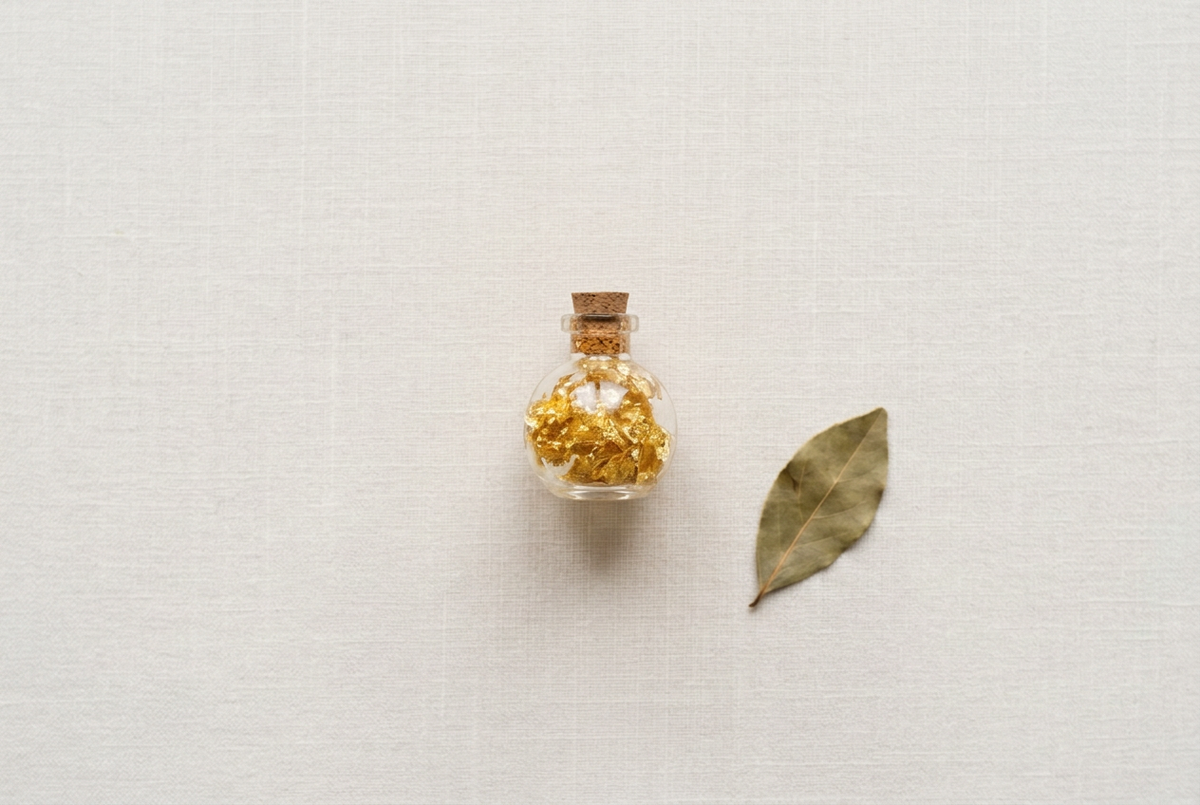 Revised flat lay with a smaller bottle beside a longer bay leaf
