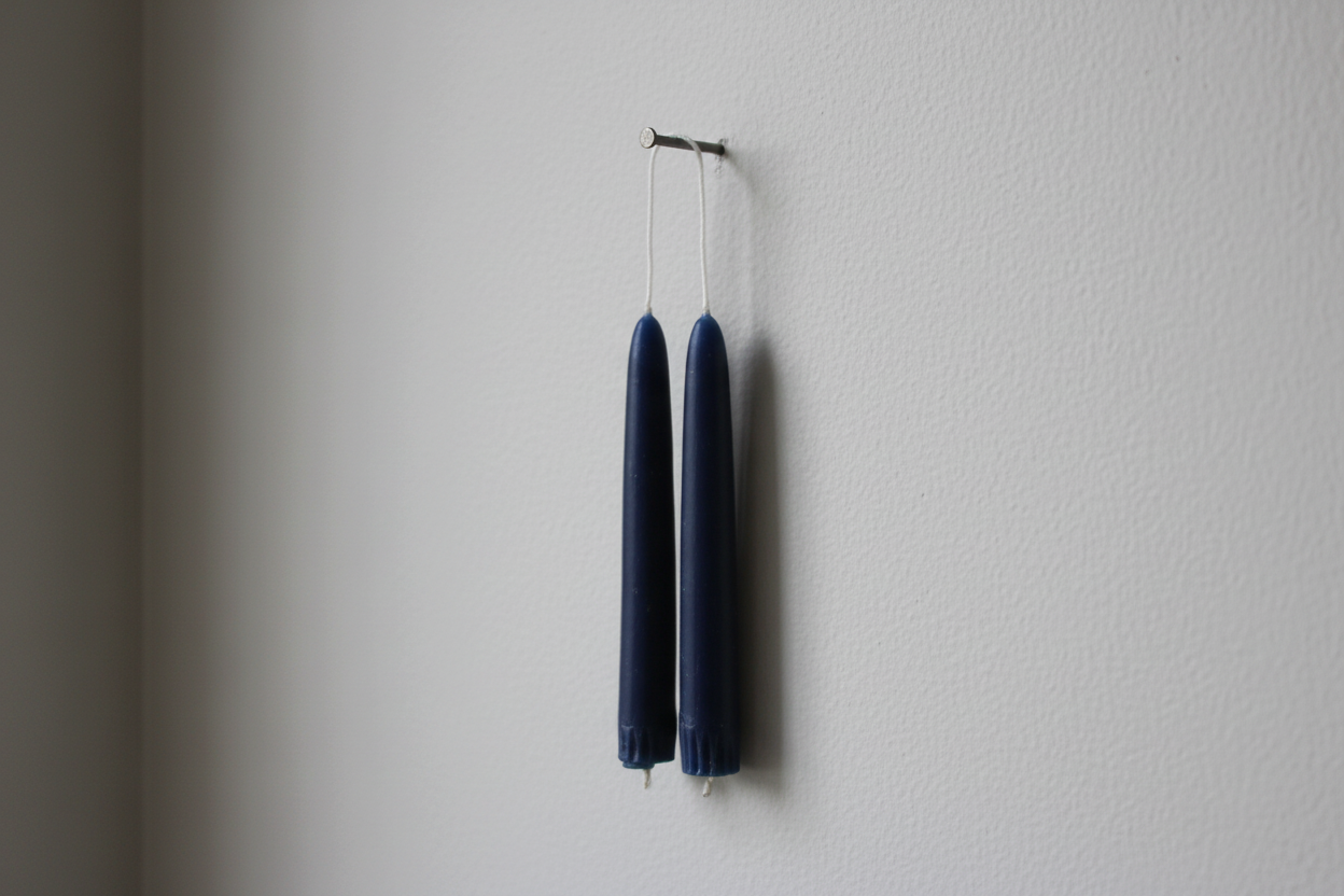 Twin Navy Taper Candles on Single Nail