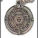 Conjuration of Powers amulet with silver-toned pendant and mystical design on a 22 1/2-inch chain.