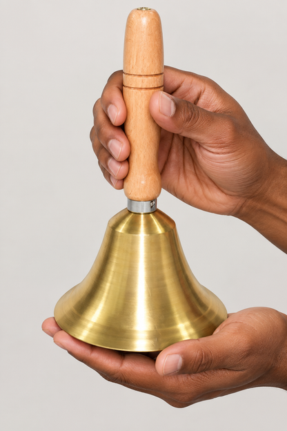 Brass and wood bell supported in hands