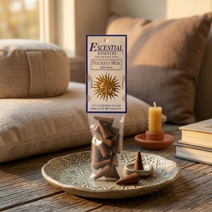 Tiny Patchouly Musk incense cone on ceramic dish within tranquil meditation environment.