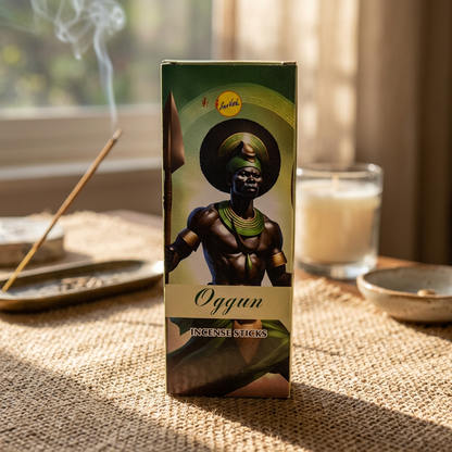 Detailed close-up of Ogun sree vani incense stick box on woven cloth, focusing on craftsmanship and earthy tones.