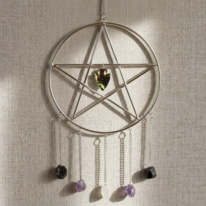 Close-up of pentagram wall hanging with stones against a neutral textured fabric background, showcasing micro-texture and sparkle.