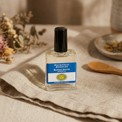 Miniature 1/2oz Summer Solstice essential oil bottle on linen cloth in warm indoor setting, highlighting micro-details and intimate mood.