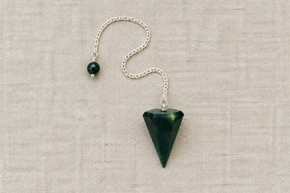 Dark green pendulum flat lay