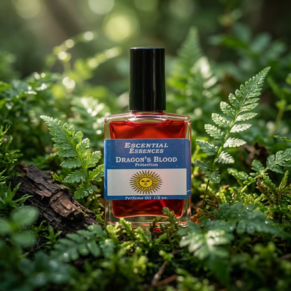 Close-up of Dragon's Blood Perfume Oil bottle among lush green leaves, highlighting transparent glass and deep red oil in soft natural light.