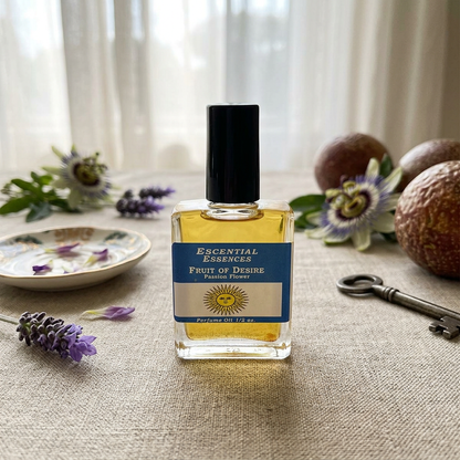 Full-body scene of a petite Passion Fruit Seduction Perfume Oil bottle on a textured fabric surface in a sophisticated vanity setting with floral hints.