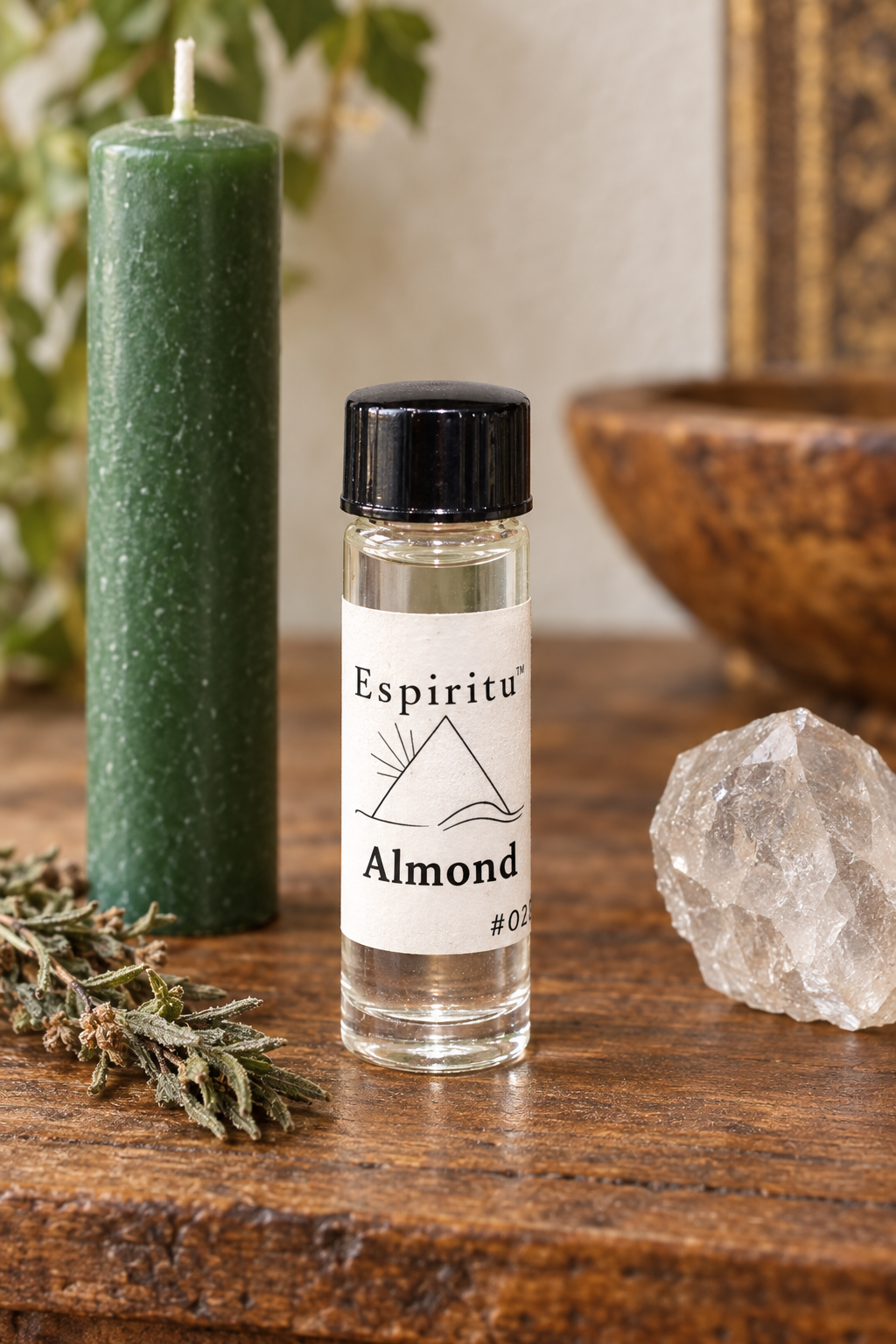 Espiritu Almond oil on an altar with an unlit green candle and crystal