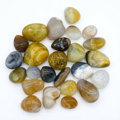 You will be generating high-quality product photos for an online stores product page. The product images should closely match the original products.
      Here is the prompt (IMPORTANT!): """Display the 'Agate Natural Tumbled Stones, 1 lb' in an elegant, m
