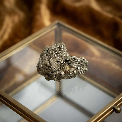 You will be generating high-quality product photos for an online stores product page. The product images should closely match the original products.
      Here is the prompt (IMPORTANT!): """Capture a close-up, hyper-realistic shot of the 'Fools Gold Charm