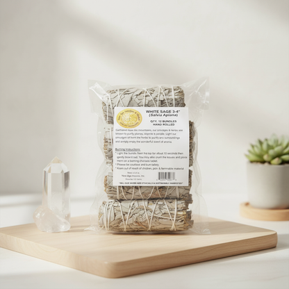 A cinematic, studio-lit shot of the White Sage Smudge Stick set in a serene, modern spiritual environment. Shot from a slightly elevated angle using a 50mm lens with a shallow depth of field, focusing sharply on the set of 12 sage sticks that are neatly bu