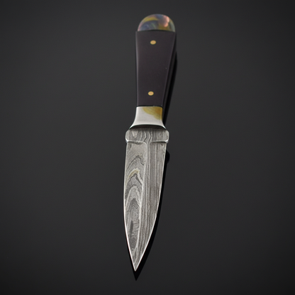 Capture a close-up, high-resolution image of the Bosom Damascus Athame, 6 1/2', displayed on a reflective black surface under soft HDR studio lighting, highlighting the intricate Damascus steel pattern with emphasis on its textured, layered blade. Use a ma