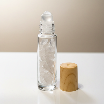 Create a highly detailed image of a 10ml quartz roller bottle, set against a luxurious, softly lit studio background. The bottle is crafted from crystal-clear, high-quality glass, showcasing the shimmering clarity of the quartz crystal inside. The scene is