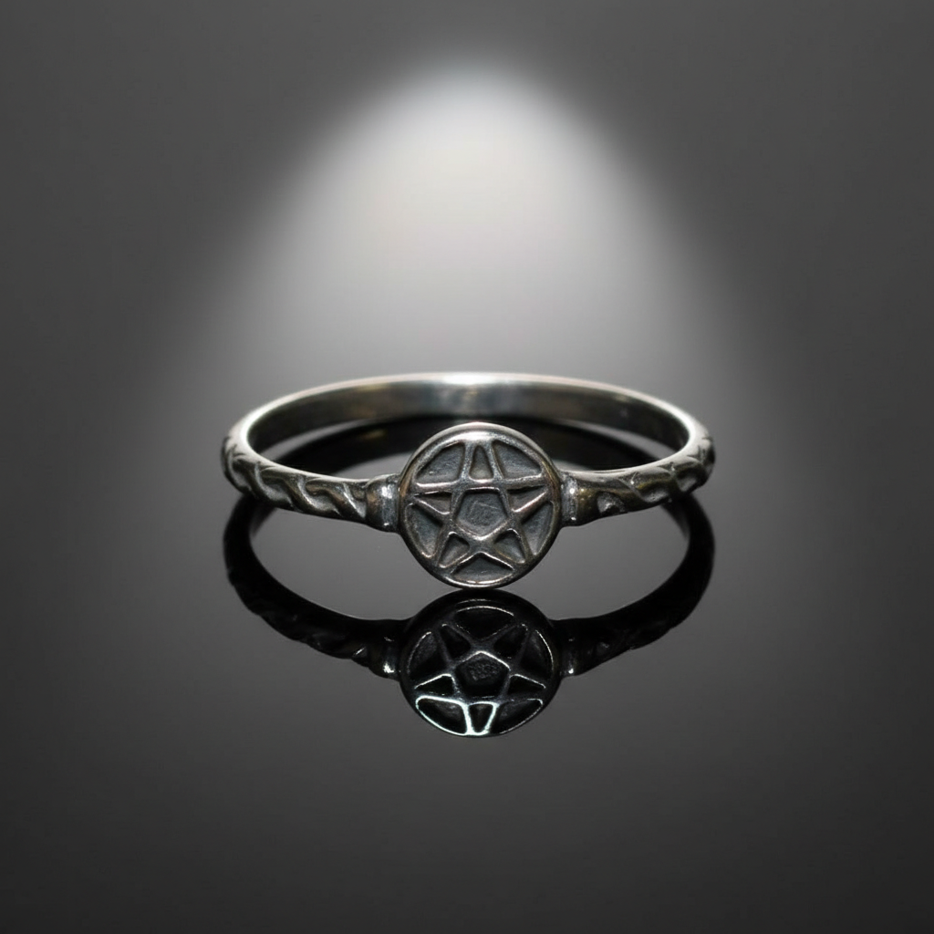 Create a highly detailed, studio-quality image of a sterling silver pentagram ring in size 6, positioned centrally on a reflective black mirror surface with soft diffusion sweeping across the scene, spotlighted by a softbox light source from above to highl