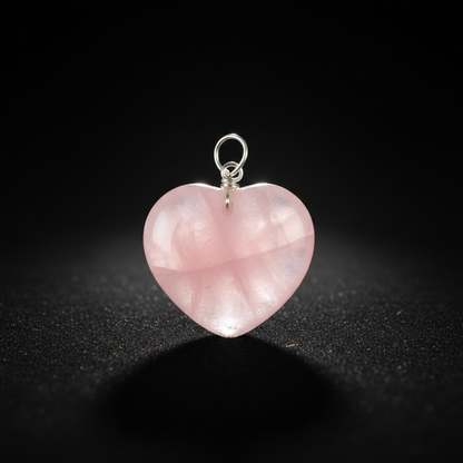 Create a high-resolution studio portrait of the Rose Quartz Heart Pendant, captured from a slightly elevated angle to emphasize the heart shape and smooth, polished surface. Use softbox lighting with HDR studio lighting to highlight the gentle translucency