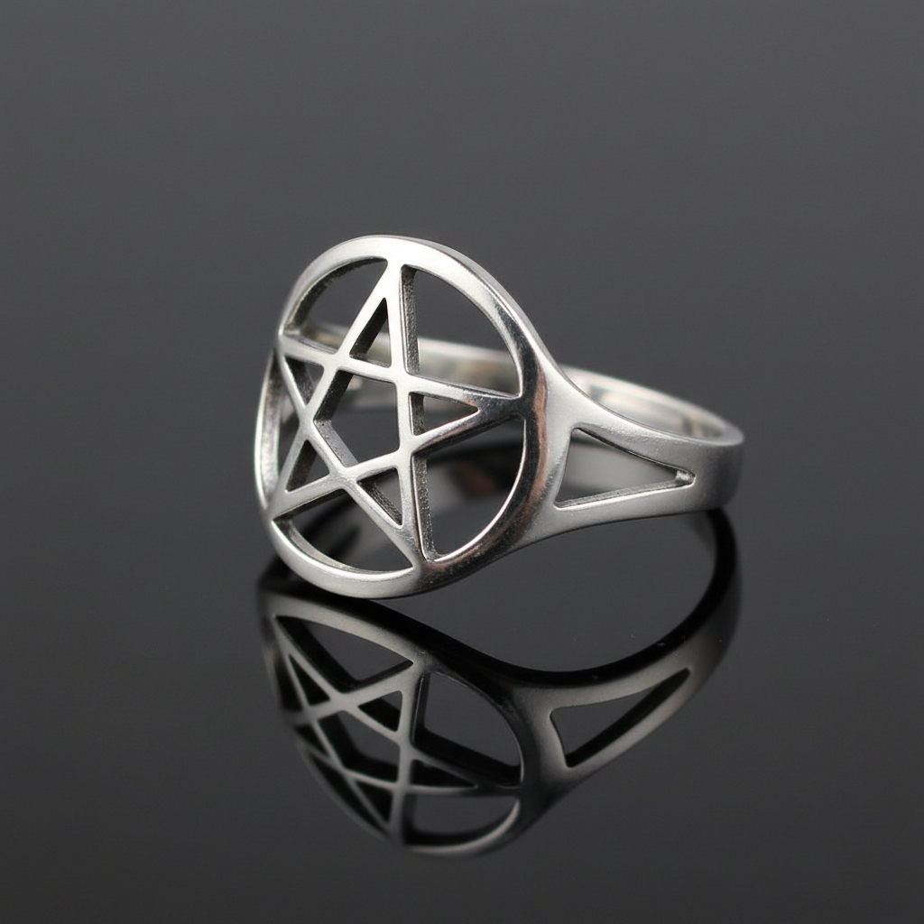 Capture a highly detailed, professional studio shot of the silver plated brass pentagram ring size 9, positioned on a sleek, reflective black surface to emphasize its metallic luster and intricate pentagram symbol. Use softbox lighting to create even, diff