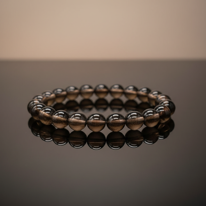 Create a highly detailed, cinematic studio shot of the Smoky Quartz Bracelet, 8mm beads, placed elegantly on a smooth, dark reflective surface under softbox lighting that emphasizes the stone's natural translucency and subtle color variations. Capture the 