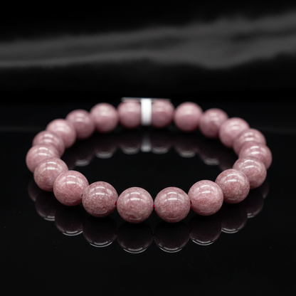 Capture a close-up shot of the Lepidolite bracelet, styled elegantly on a reflective black surface, illuminated with soft HDR studio lighting that highlights the smooth 8mm polished stones' subtle lilac hues and natural crystalline textures. Use a macro le