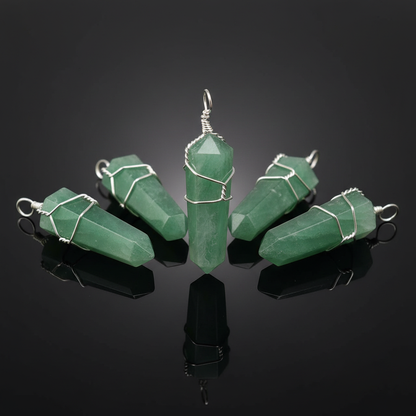 Create a luxurious, high-resolution studio shot of a set of five Green Aventurine point pendants, each about 1 3/8 inches long, arranged in an elegant semi-circle on a reflective black glass surface. The lighting involves softbox diffuse daylight to highli