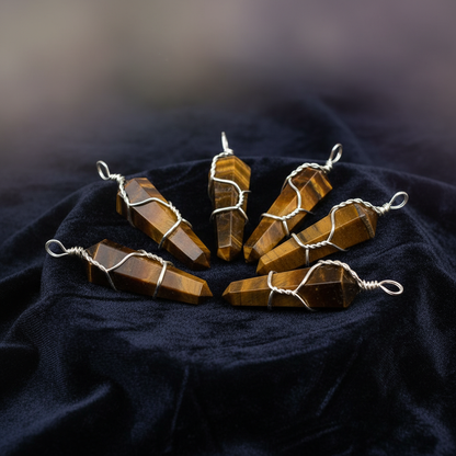 Create a highly detailed studio product shot of a set of five wire-wrapped Tiger Eye crystal points, each approximately 1 3/8 inches long, arranged artistically on a textured dark velvet cloth, emphasized with softbox lighting to highlight the silky luster