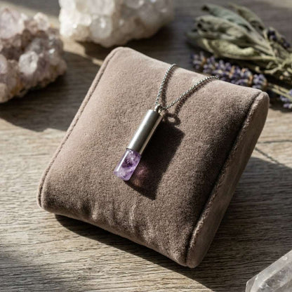Full view of petite amethyst pendant on velvet cushion, highlighting craftsmanship and subtle hidden chamber detail.