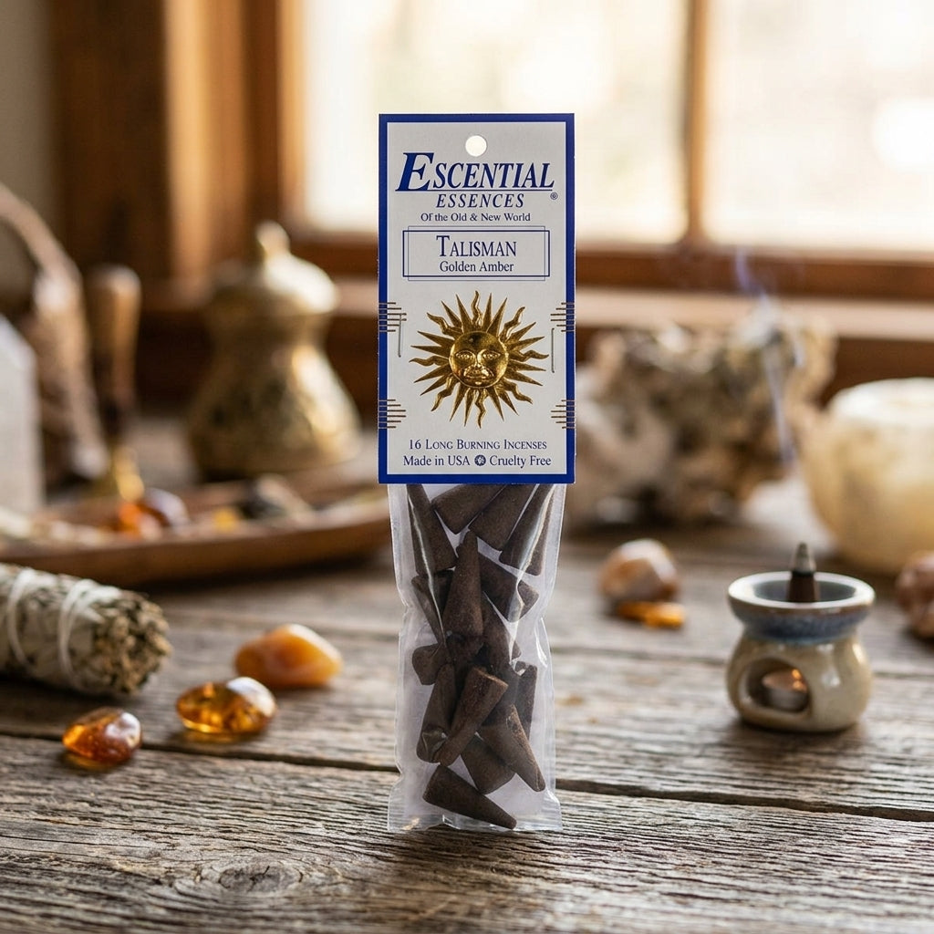 Close-up of a golden amber incense cone with textured surface and soft glow in a cozy, natural room setting.