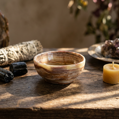 Photorealistic 3-inch green onyx bowl on a natural wooden altar, illuminated by soft natural light, showcasing intricate veining and smooth texture.