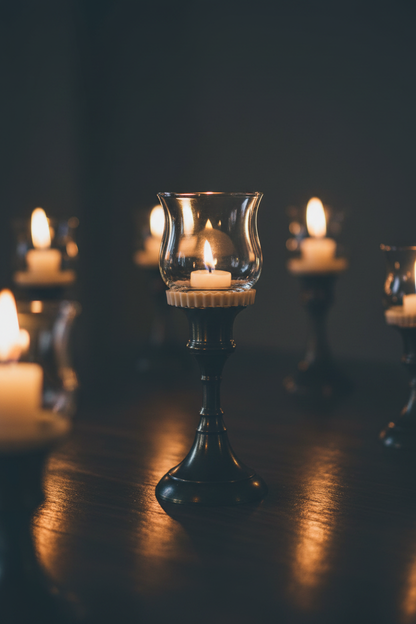 Rubber votive peg adapter installed on a taper candlestick holder with votive on top