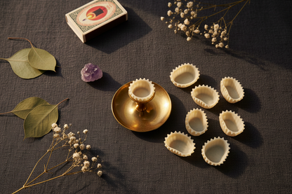 Flat-lay of votive peg adapter set of 10 with botanicals and crystals