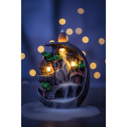 Fairy Scape Backflow Incense Burner in an enchanted nighttime scene with blue and purple twilight and bokeh fairy lights