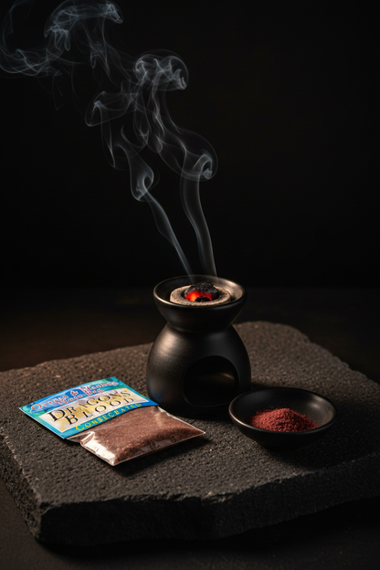 Consecrated Dragon's Blood Resin bag beside black ceramic censer with smoke and matte red powder in dark dish