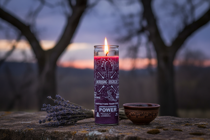 Uncrossing 7-day purple jar candle on a rustic stone surface at twilight with dried lavender bundle and offering bowl