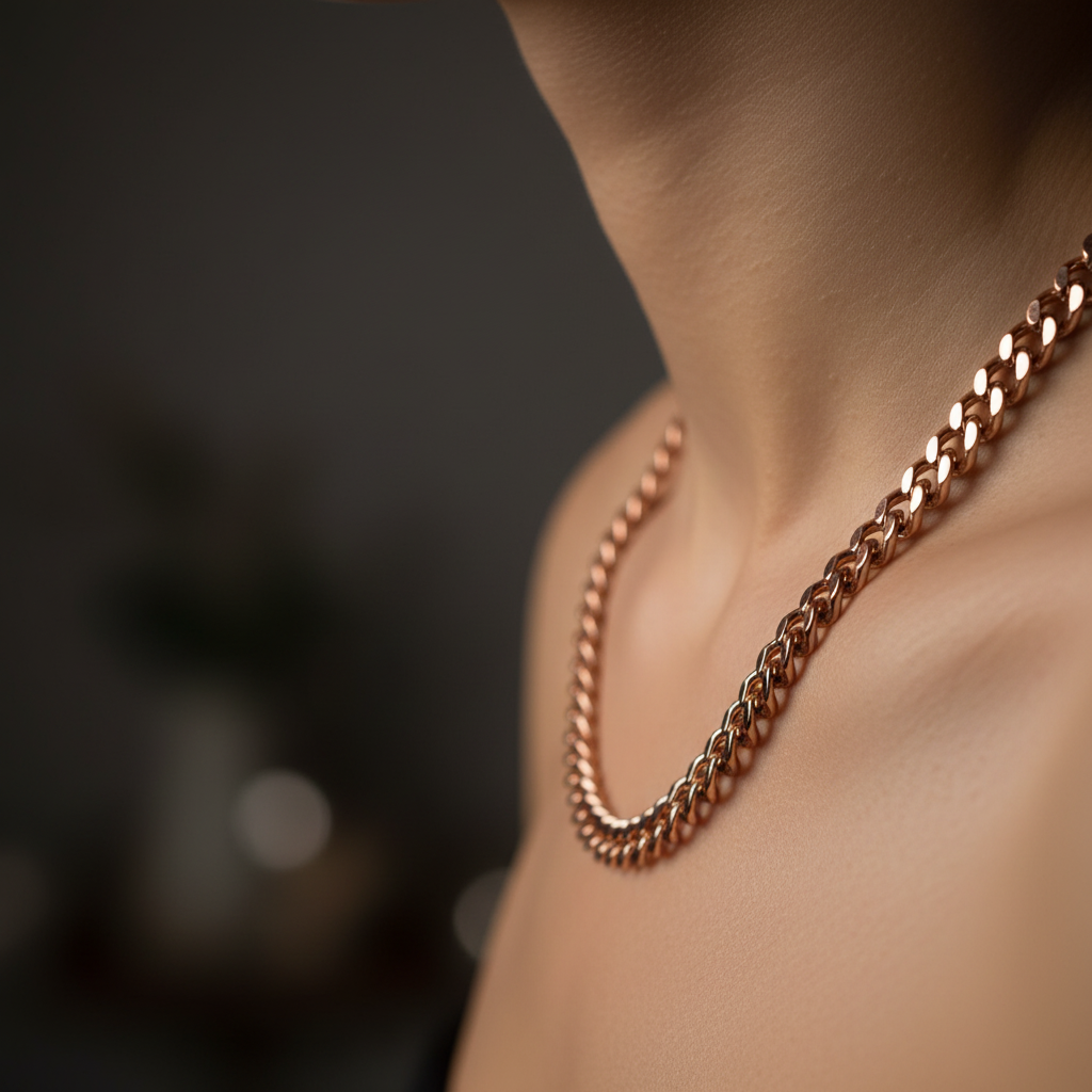 Close-up of copper heavy chain necklace worn on a model's neck showing chain detail against bare skin