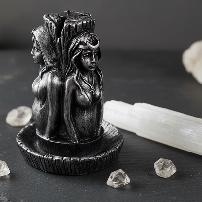 Maiden, Mother, Crone backflow incense burner close-up with selenite crystals and quartz on dark slate