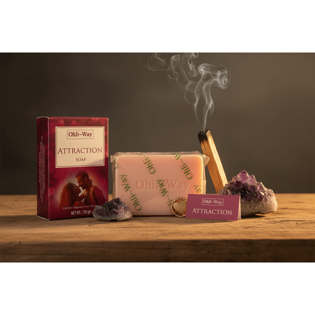 Ohli-Way Attraction Soap set with pink bar, burgundy box, gold heart charm and prayer card on wooden altar with palo santo and amethyst crystal