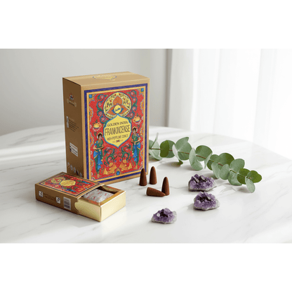 Golden India Frankincense incense cones and box on white marble with botanicals and amethyst crystals