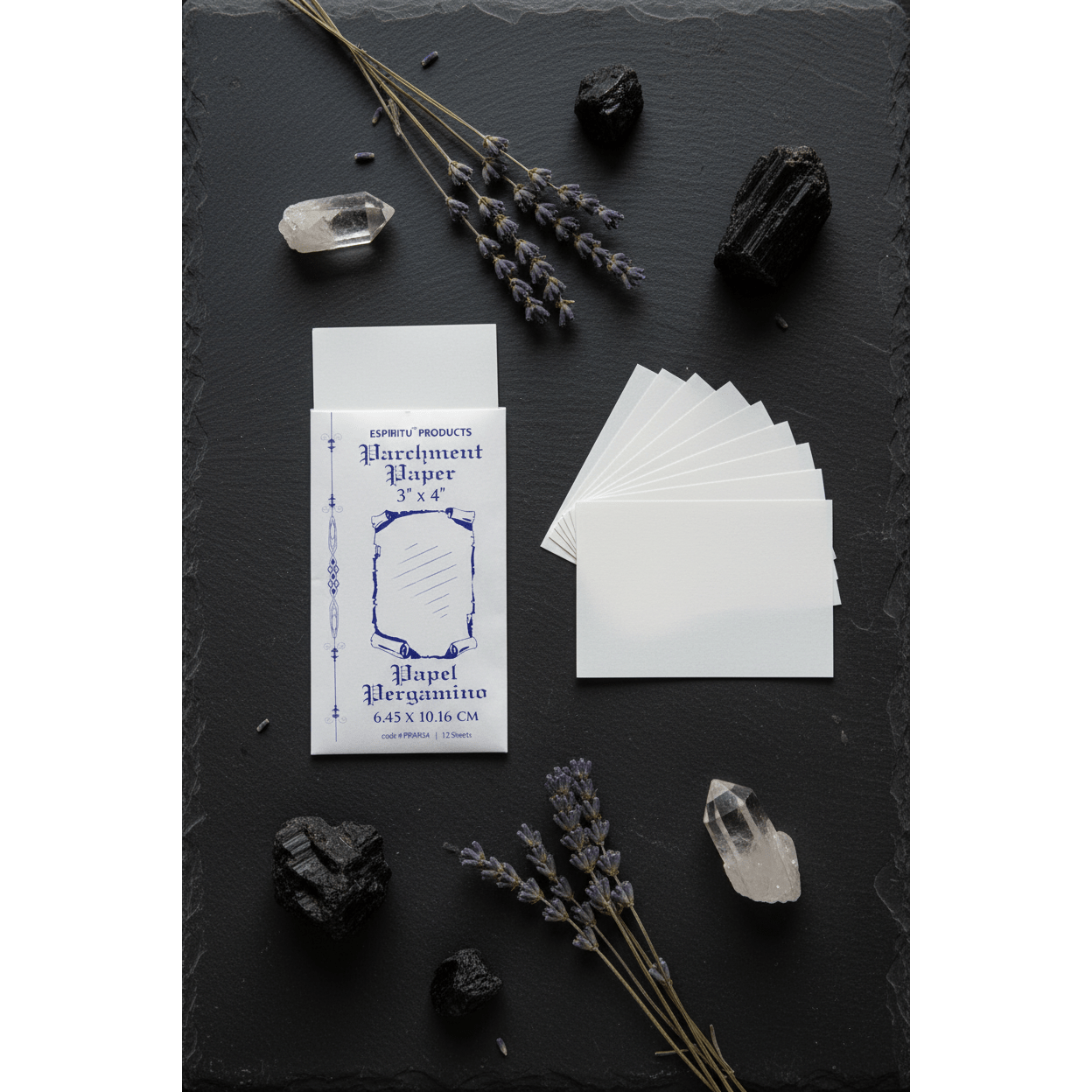3" x 4" parchment paper sheets by Espiritu sliding out of matching envelope, flat lay with crystals and dried lavender on dark slate