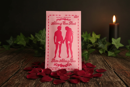 Adam and Eve Root Espiritu packaging on dark wooden surface with rose petals and candlelight